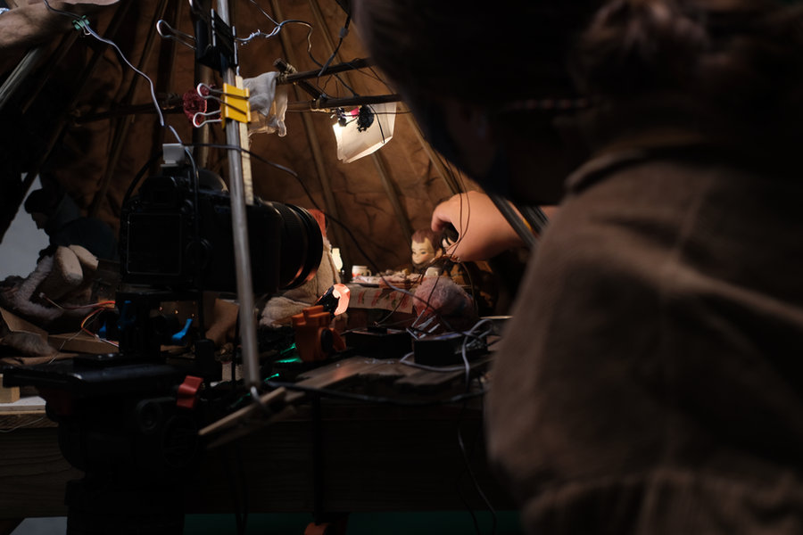 An animator moving a puppet between the rig and the lights